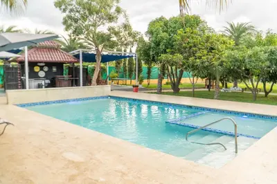 a swimming pool at a resort with trees in the background at Terrenal Paradise in Esperanza