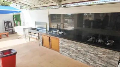 a kitchen with a sink and a counter top at Terrenal Paradise in Esperanza