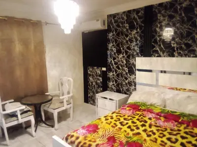 a bedroom with a bed and a table and a chair at SML Garden Apartament in La Romana