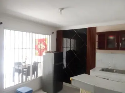 a kitchen with a refrigerator and a table and a window at SML Garden Apartament in La Romana