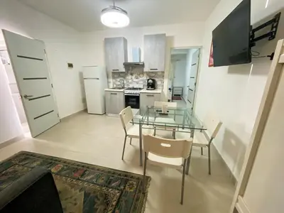 a dining room with a glass table and chairs at Vintage Villa confortable apartments Wifi private pool free parking in Boca Chica