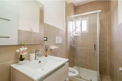 a bathroom with a sink and a shower and a toilet at Vintage Villa confortable apartments Wifi private pool free parking in Boca Chica