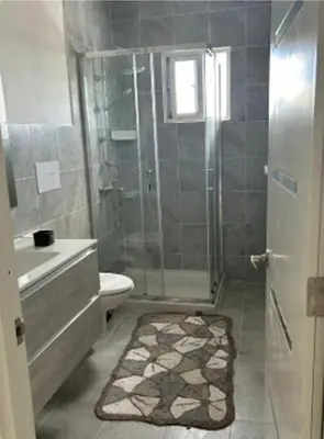 a bathroom with a shower and a toilet and a sink at Vintage Villa confortable apartments Wifi private pool free parking in Boca Chica