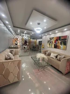 a living room with two couches and a table at Moderno y amplio apartamento en Santiago in Carlos Guerra