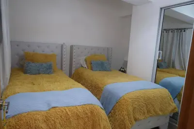 a bedroom with two beds and a large mirror at Boca Chica in Boca Chica