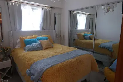a bedroom with two beds and a large mirror at Boca Chica in Boca Chica