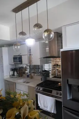 a kitchen with a stove and several lights at Boca Chica in Boca Chica