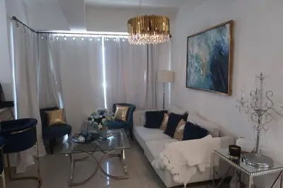 a living room with a couch and chairs and a chandelier at Boca Chica in Boca Chica