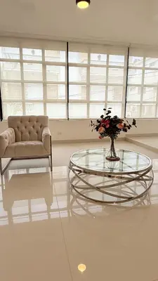 a living room with a glass table and a couch at Soho loft residence in Santo Domingo