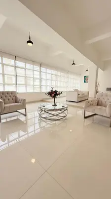 a large white living room with a table and couches at Soho loft residence in Santo Domingo