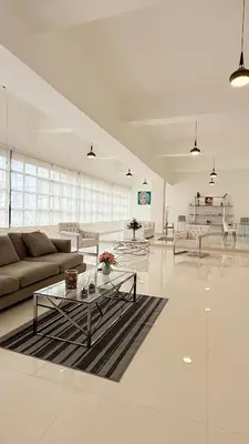 a white living room with a couch and a table at Soho loft residence in Santo Domingo