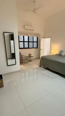 a large bedroom with a bed and a mirror at Soho loft residence in Santo Domingo