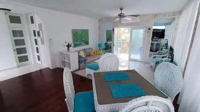 a dining room and living room with a table and chairs at Cabarete Heartbeat Suite, 1 BR in Cabarete