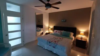 a bedroom with a bed and a ceiling fan at Cabarete Heartbeat Suite, 1 BR in Cabarete