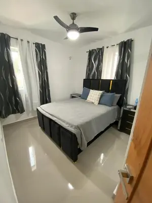a bedroom with a bed and a ceiling fan at Cozy Tropical Getaway in Los Altos de Jalisco