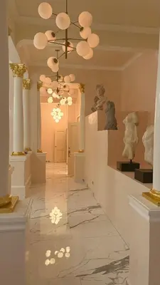 a hallway in a museum with a chandelier and statues at Exclusive Soho Loft Residence in Santo Domingo