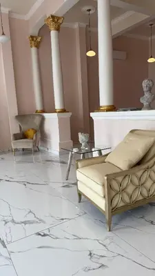 a living room with a couch and a table and columns at Exclusive Soho Loft Residence in Santo Domingo