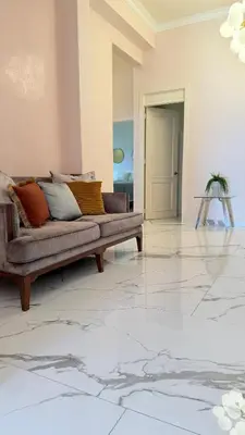 a living room with a couch on a marble floor at Exclusive Soho Loft Residence in Santo Domingo