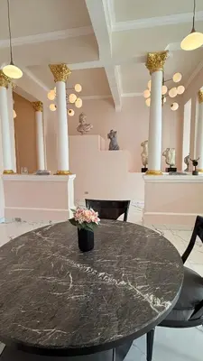 a black table with a vase with flowers on it at Exclusive Soho Loft Residence in Santo Domingo