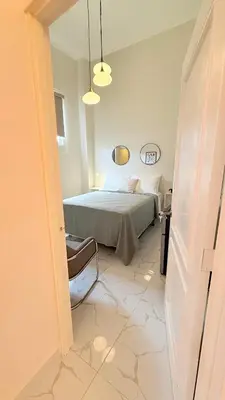 a bedroom with a bed and a room with a mirror at Exclusive Soho Loft Residence in Santo Domingo