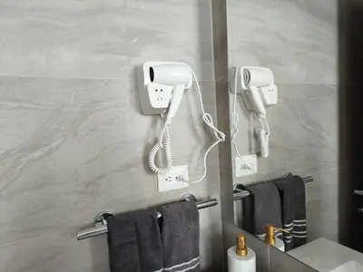 a bathroom with a phone and towels at Apartamento Cómodo en Punta Cana in Punta Cana