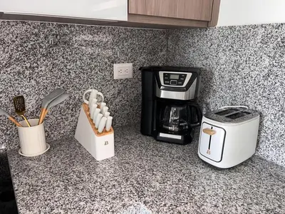 a kitchen counter with a coffee maker and a toaster at Apartamento Cómodo en Punta Cana in Punta Cana