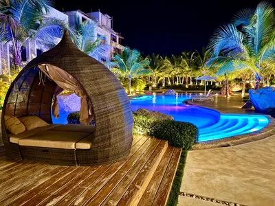 a gazebo by a swimming pool at night at Tropical Escape with 3 Pools & Private Beach Club Aqua Esmeralda in La Laguna