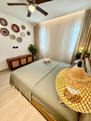 a bedroom with a bed with a hat on it at Tropical Escape with 3 Pools & Private Beach Club Aqua Esmeralda in La Laguna
