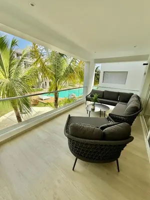 a living room with a couch and a table at Tropical Escape with 3 Pools & Private Beach Club Aqua Esmeralda in La Laguna