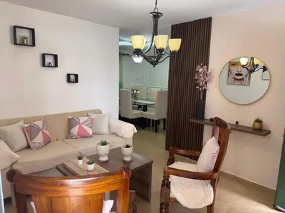 a living room with a couch and a table at Acogedor y céntrico apartamento en Palmas de Gurabo in Santiago de los Caballeros