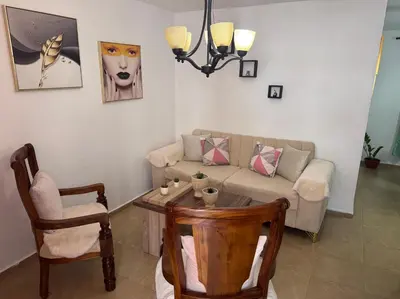 a living room with a couch and a table at Acogedor y céntrico apartamento en Palmas de Gurabo in Santiago de los Caballeros