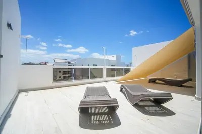 a balcony with two benches on top of a building at La casa del Maestro apartment in Bayahibe