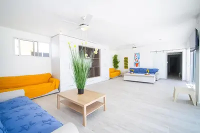 a living room with yellow and blue couches and a table at La casa del Maestro apartment in Bayahibe