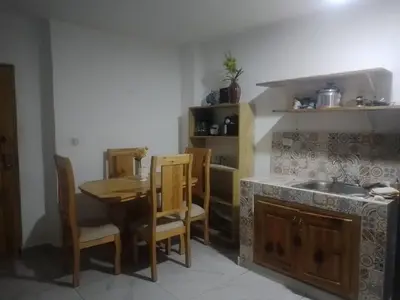 a kitchen with a table and chairs and a sink at Home Realty in Santo Domingo