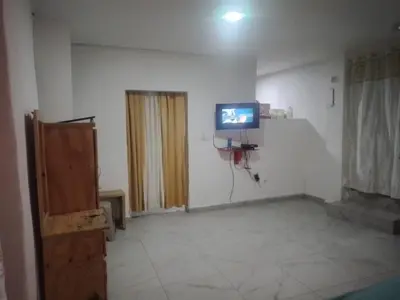 a living room with a tv on the wall at Home Realty in Santo Domingo