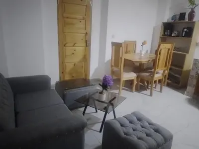 a living room with a couch and a table at Home Realty in Santo Domingo