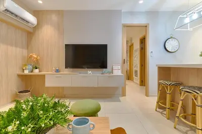 a living room with a tv on a wall at ®{Peaceful~Retreat} @DowntownSD HotTubGymFamily in Santo Domingo
