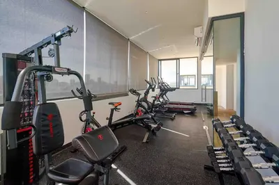 a gym with several exercise bikes in a room at ®{Peaceful~Retreat} @DowntownSD HotTubGymFamily in Santo Domingo