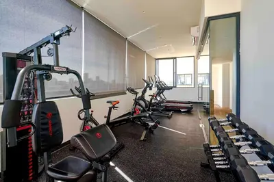 a gym with several exercise bikes in a room at ®{Peaceful~Retreat} @DowntownSD HotTubGymFamily in Santo Domingo