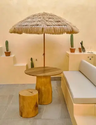 a table with a bench and a table with an umbrella at ®{Tulum~Experience}@Downtown PoolViewPenthouse in Santo Domingo
