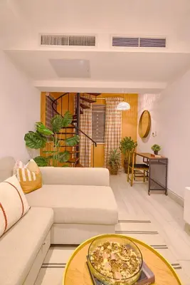 a living room with a white couch and a table at ®{Tulum~Experience}@Downtown PoolViewPenthouse in Santo Domingo