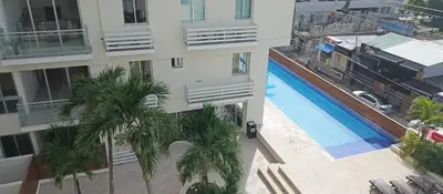 an overhead view of a building with a pool and palm trees at Apartamento en Boca Chica T3 602 in Boca Chica
