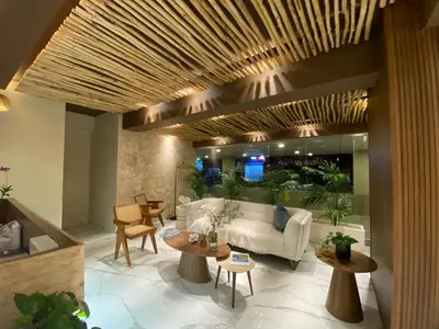 a living room with a white couch and tables at Apartamento en Boca Chica T3 602 in Boca Chica