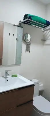 a bathroom with a sink and a mirror and a toilet at Apartamento en Boca Chica T3 602 in Boca Chica