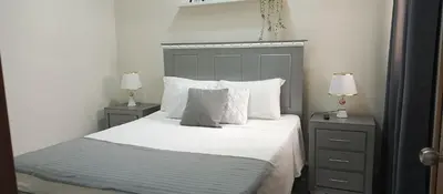 a bedroom with a bed with white sheets and pillows at Apartamento en Boca Chica T3 602 in Boca Chica