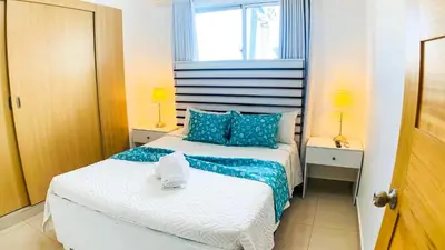 a bedroom with two beds with blue and white at Apartamento en Boca Chica T1 302 in Boca Chica