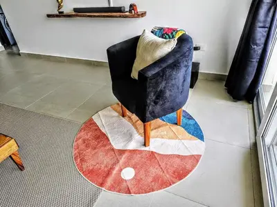 a chair sitting on a rug in a room at NEW Luxury at Sosua Ocean Village Laguna City in Sosúa