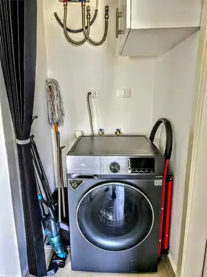 a washer and dryer in a small room at NEW Luxury at Sosua Ocean Village Laguna City in Sosúa