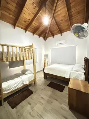 two bunk beds in a room with wooden ceilings at Villa escondida in San Cristóbal