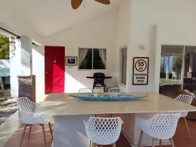 a kitchen with a table and chairs in a room at Villa en Guababerry in Los Conucos